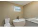 Modern bathroom with a freestanding tub and gray vanity at 2602 Cr 422, Lake Panasoffkee, FL 33538