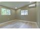 Spacious bedroom with light wood flooring and large windows at 2602 Cr 422, Lake Panasoffkee, FL 33538