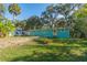 Teal house with orange door and a large backyard at 2602 Cr 422, Lake Panasoffkee, FL 33538