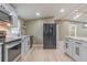 Modern kitchen with gray cabinets, granite countertops, and stainless steel appliances at 2602 Cr 422, Lake Panasoffkee, FL 33538