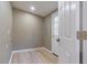Small laundry room with vinyl flooring and white door at 2602 Cr 422, Lake Panasoffkee, FL 33538