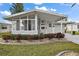 Front view of a single-wide manufactured home with a covered entryway and landscaping at 3217 Manatee Rd, Tavares, FL 32778