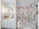 Large bathroom with walk-in shower and marble walls at 39851 & 39855 Darlington Ave, Lady Lake, FL 32159