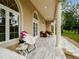 Relaxing covered patio with tiled flooring and outdoor seating at 39851 & 39855 Darlington Ave, Lady Lake, FL 32159