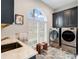 Laundry room with modern appliances and a farmhouse sink at 39851 & 39855 Darlington Ave, Lady Lake, FL 32159