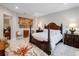 Elegant main bedroom with a four poster bed and stylish decor at 39851 & 39855 Darlington Ave, Lady Lake, FL 32159