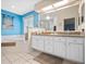 Double vanity bathroom with granite countertops, soaking tub, and separate shower at 5416 Essex Ct, Leesburg, FL 34748