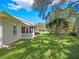Spacious backyard with lush green grass and mature trees at 5416 Essex Ct, Leesburg, FL 34748