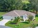 Single-story home with two-car garage and landscaped yard at 5416 Essex Ct, Leesburg, FL 34748