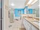 Double vanity bathroom with granite countertops, soaking tub, and separate shower at 5416 Essex Ct, Leesburg, FL 34748