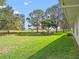 Serene backyard view with mature trees and open space at 5416 Essex Ct, Leesburg, FL 34748