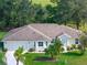 Single-story home with two-car garage and landscaped yard at 5416 Essex Ct, Leesburg, FL 34748