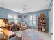 Bright home office features built-in shelving and a comfortable seating area at 5416 Essex Ct, Leesburg, FL 34748