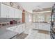 White kitchen with granite countertops and breakfast nook at 5416 Essex Ct, Leesburg, FL 34748