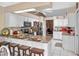 Modern kitchen with white cabinets, granite countertops, and breakfast bar at 5416 Essex Ct, Leesburg, FL 34748