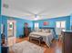 Spacious bedroom with king-size bed, wood flooring, and ensuite bathroom access at 5416 Essex Ct, Leesburg, FL 34748