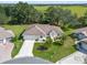 Single-story home with two-car garage and landscaped yard at 5416 Essex Ct, Leesburg, FL 34748