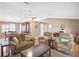 Bright living room with hardwood floors, comfy seating, and large windows at 5416 Essex Ct, Leesburg, FL 34748