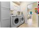 Bright laundry room with washer, dryer, and built-in cabinets at 5480 Bounty Cir, Tavares, FL 32778