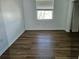 Simple bedroom with wood-look floors and window at 652 Chelsea Dr, Davenport, FL 33897