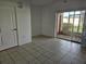 Living room with tile floor, sliding doors to patio, and ceiling fan at 652 Chelsea Dr, Davenport, FL 33897