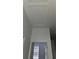 Upper hallway with attic access and door to bedroom at 652 Chelsea Dr, Davenport, FL 33897