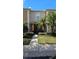 Tan two-story townhome with dark brown door, landscaping, and walkway at 652 Chelsea Dr, Davenport, FL 33897