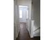 Hallway with wood-look floors and access to rooms at 652 Chelsea Dr, Davenport, FL 33897