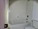 Bathroom with tub, toilet, and tiled walls at 652 Chelsea Dr, Davenport, FL 33897