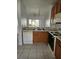 Kitchen with wood cabinets, double sink, and view to backyard at 652 Chelsea Dr, Davenport, FL 33897
