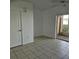 Bright living room with tile floors and sliding glass door to patio at 652 Chelsea Dr, Davenport, FL 33897