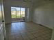 Living room with tile floors and sliding doors to patio at 652 Chelsea Dr, Davenport, FL 33897