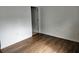Simple bedroom with wood-look floors and door to bathroom at 652 Chelsea Dr, Davenport, FL 33897