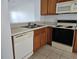 Kitchen with wood cabinets, appliances, and tile floor at 652 Chelsea Dr, Davenport, FL 33897