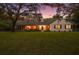 Charming ranch home with a spacious lawn, mature trees, and a beautiful sunset view at 9345 Silver Lake Dr, Leesburg, FL 34788