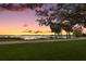 Scenic lake view with tranquil sunset and lush greenery at 9345 Silver Lake Dr, Leesburg, FL 34788
