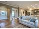 Open living room with light colored sofa and kitchen view at 1010 Nantucket Sound, Mount Dora, FL 32757