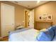 Cozy bedroom with a queen bed, dresser and access to hallway at 1010 Nantucket Sound, Mount Dora, FL 32757