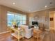 Light-filled living room featuring hardwood floors, large windows, and comfortable furniture at 1010 Nantucket Sound, Mount Dora, FL 32757