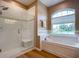 Spa-like bathroom with a walk-in shower and soaking tub at 1010 Nantucket Sound, Mount Dora, FL 32757
