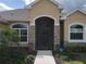 Front entrance with a screened porch and stone accents at 1010 Nantucket Sound, Mount Dora, FL 32757