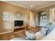Bright living room with hardwood floors, comfy seating, and stylish wall decor at 1010 Nantucket Sound, Mount Dora, FL 32757