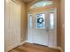 Light and bright entryway with white door and wood floors at 1010 Nantucket Sound, Mount Dora, FL 32757