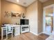 Home office with desk, TV, and built-in shelving at 1010 Nantucket Sound, Mount Dora, FL 32757