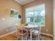 Bright breakfast nook with wood table and chairs at 1010 Nantucket Sound, Mount Dora, FL 32757