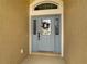 Front door with a light blue door and glass panels at 1010 Nantucket Sound, Mount Dora, FL 32757