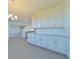 Eat-in kitchen with white cabinets and granite countertops at 14225 Crest Palm Ave, Windermere, FL 34786