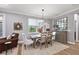 Bright dining room features a rustic wooden table with seating for four and a large mirror at 16824 Beauclaire Ct, Tavares, FL 32778