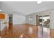 Open living area with hardwood floors and kitchen access at 17478 Se 77Th Sycamore Ave, The Villages, FL 32162