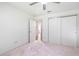 Simple bedroom featuring neutral walls and carpet, plus a door to hallway at 17478 Se 77Th Sycamore Ave, The Villages, FL 32162